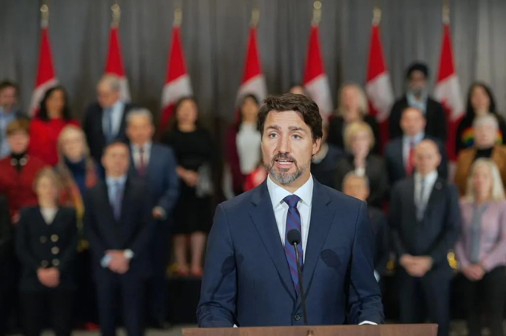 Prime Minister Justin Trudeau stands in front of his cabinet as he speaks to media during the final day of the Liberal cabinet retreat at the Fairmont Hotel in Winnipeg, on Jan. 21, 2020. (Mike Sudoma/The Canadian Press)