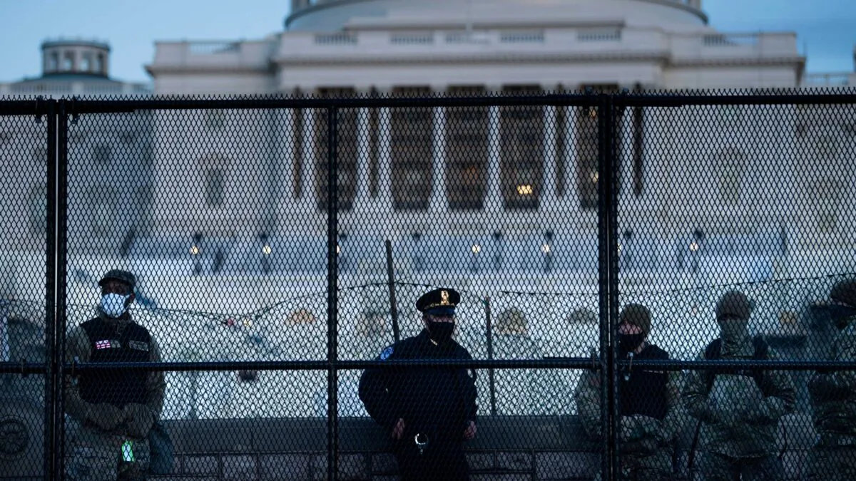 A Capitol Police officer stands with members of the National Guard behind a crowd control fence surrounding Capitol Hill in Washington on Jan. 7, 2021. (Brendan Smialowski/AFP via Getty Images)