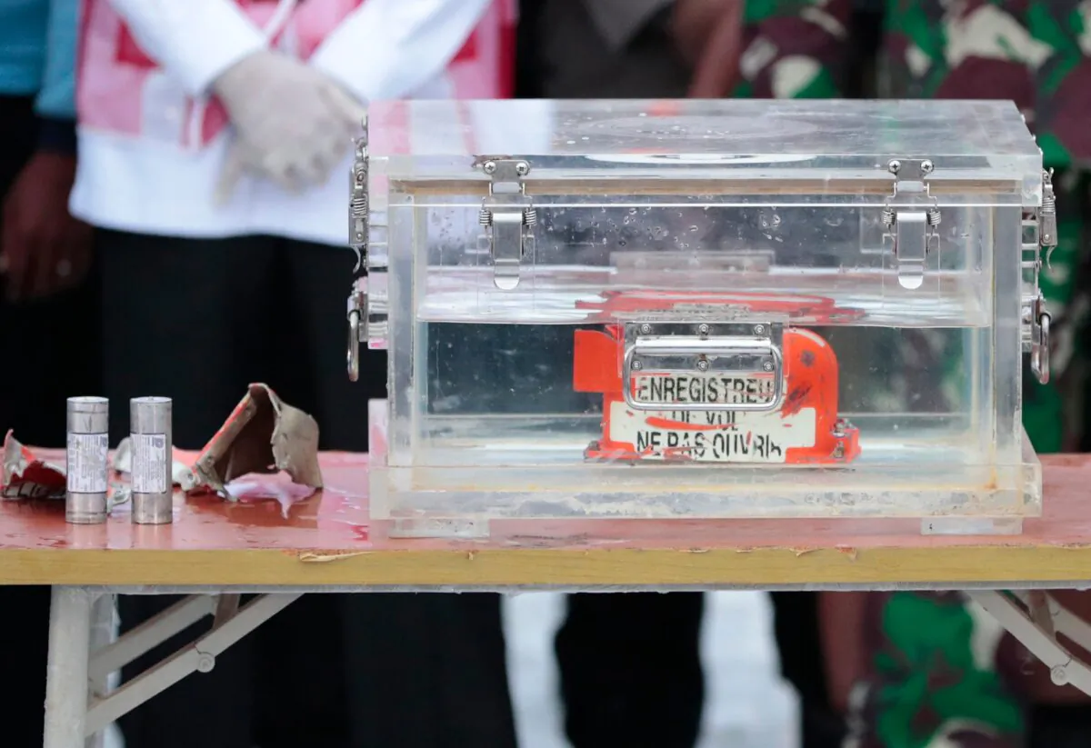 A box containing the flight data recorder recovered from the crash site of the Sriwijaya Air flight SJ-182 in the Java Sea sits on display at Tanjung Priok Port, on Jan. 12, 2021. (Dita Alangkara/AP Photo)
