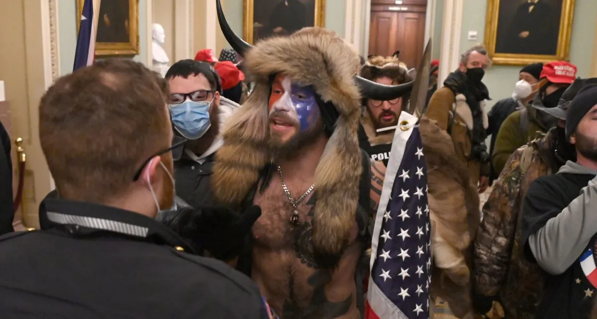 Jake Angeli (C) entered the Capitol building during a protest with his painted face and horned hat in Washington on Jan. 6, 2021. (Saul Loeb/AFP via Getty Images)