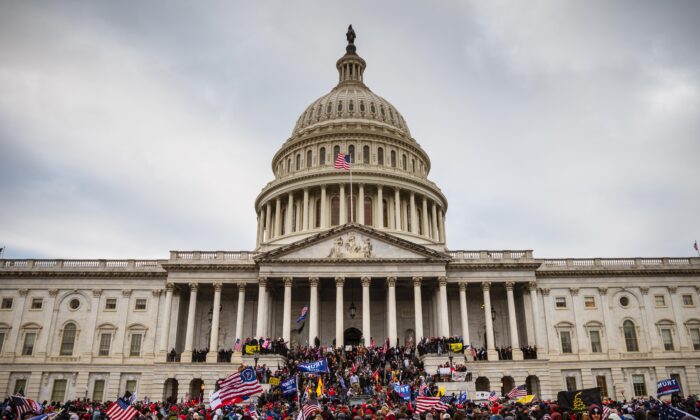 A large group of protesters stand on the East steps of the Capitol Building after storming its grounds in Washington, on Jan. 6, 2021. (Jon Cherry/Getty Images)