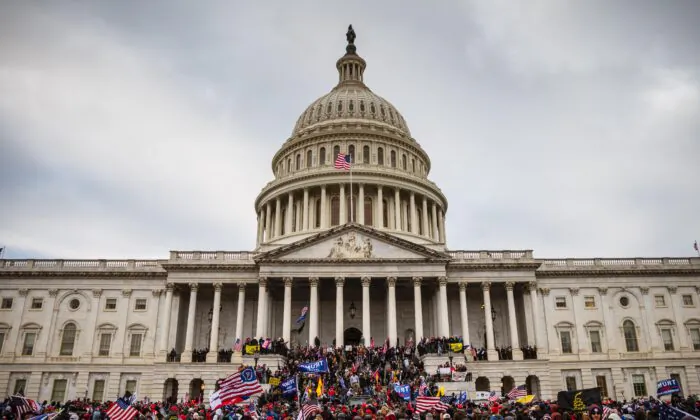 A large group of protesters stand on the East steps of the Capitol Building in Washington, on Jan. 6, 2021. (Jon Cherry/Getty Images)