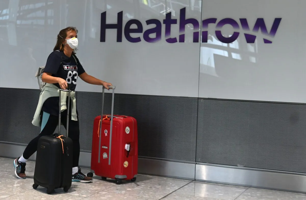 Passengers arrive at Heathrow Airport, west London, on July 10, 2020. (Daniel Leal-Olivas/AFP via Getty Images)
