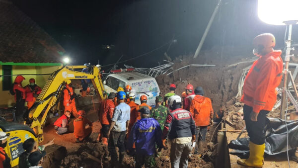 Rescuers work the scene of a landslide