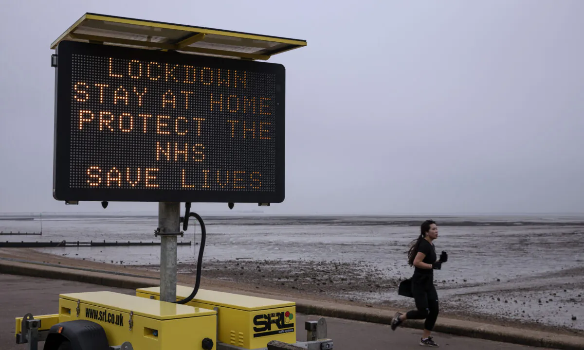 A sign asking people to stay at home stands on the sea front in Southend, England on Jan. 08, 2021.  (Dan Kitwood/Getty Images)