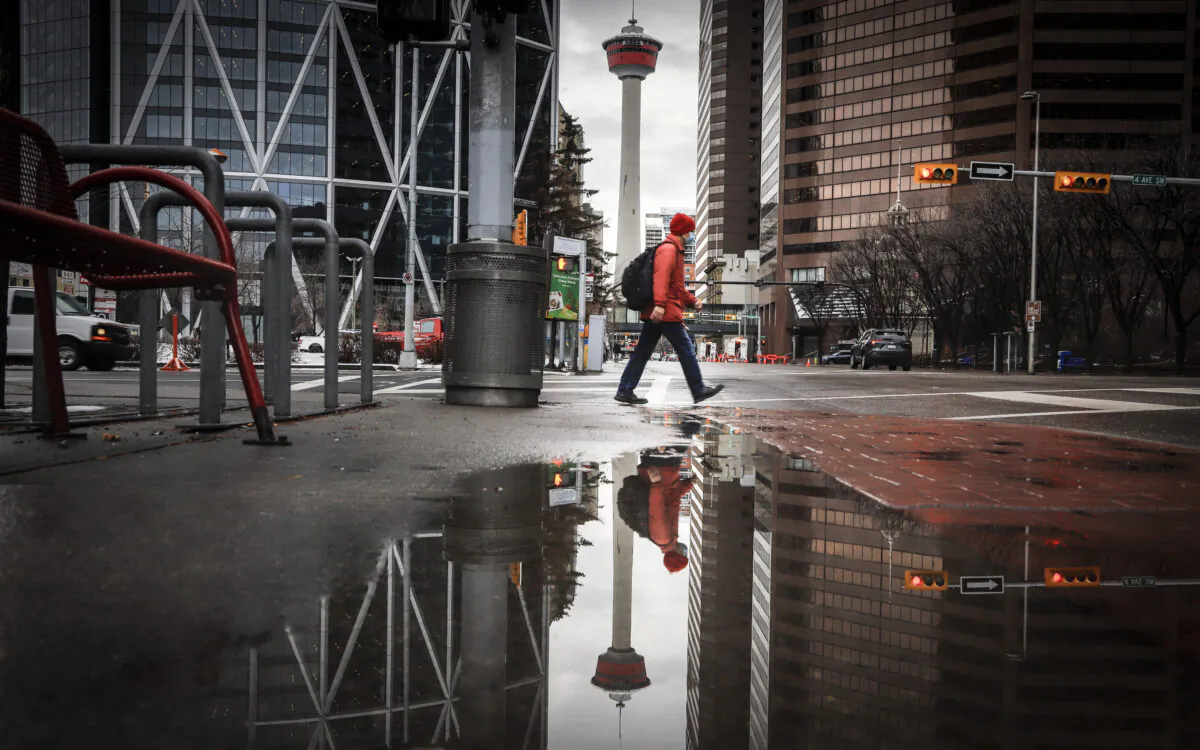 A pedestrian walks through an empty downtown Calgary amid government lockdown policies on Dec. 9, 2020. (The Canadian Press/Jeff McIntosh)