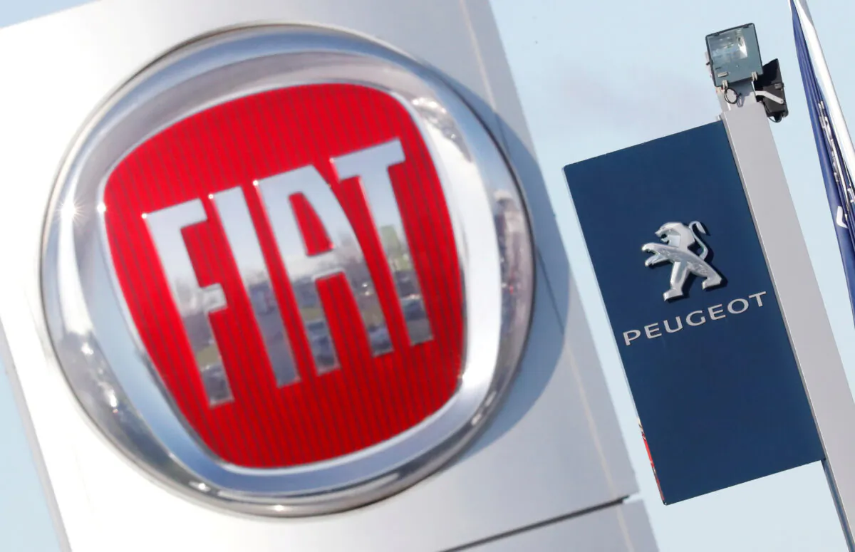 The logos of Fiat and Peugeot are seen in Saint-Nazaire, France, on Nov. 8, 2019. (Stephane Mahe/Reuters)