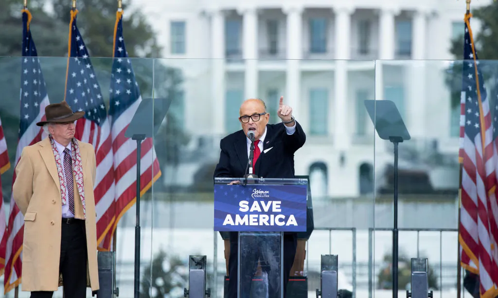 Chapman University law professor John Eastman (L) watches as Rudy Giuliani speaks to supporters from the Ellipse, near the White House on Jan. 6, 2021. (Brendan Smialowski/AFP via Getty Images)