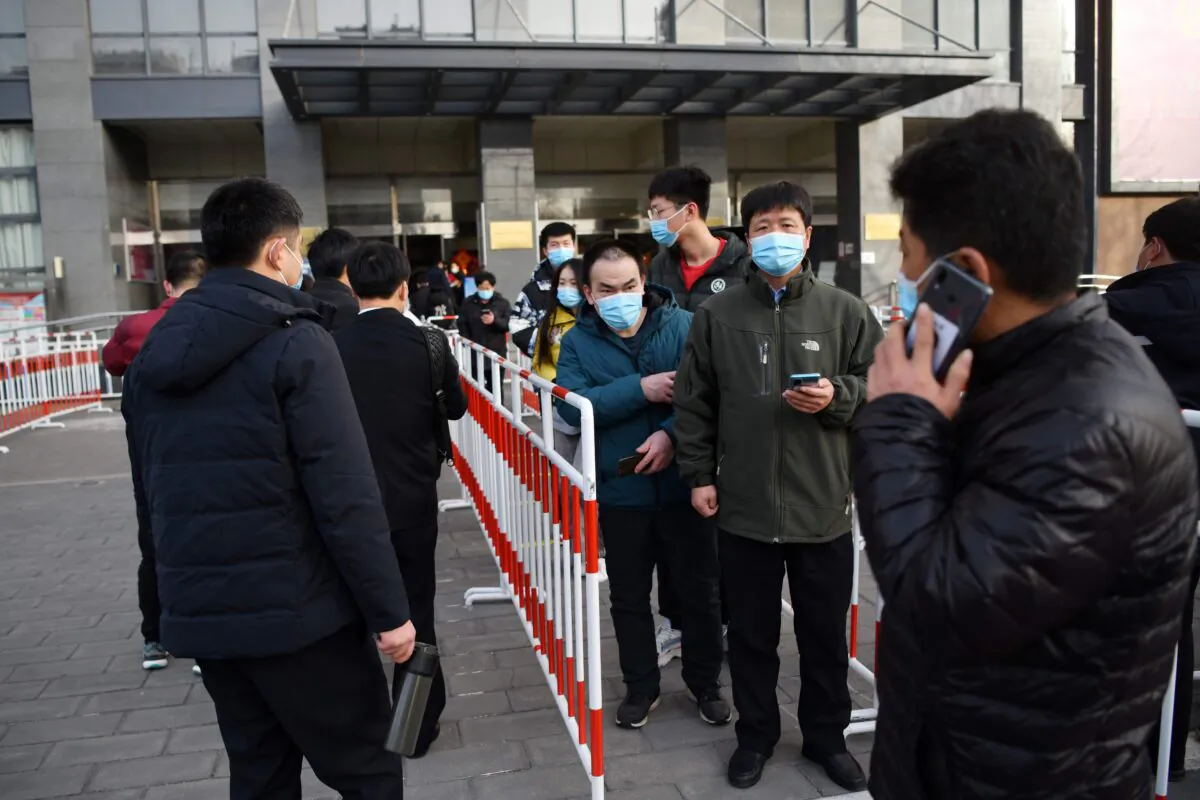 Residents line up outside a community center to be vaccinated against COVID-19 in Beijing on Jan. 12, 2021. (GREG BAKER/AFP via Getty Images)