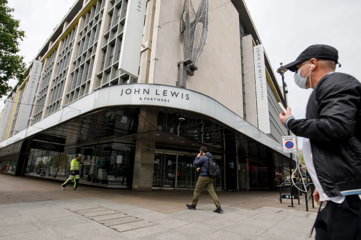 A man walks past a John Lewis department store, closed-down due to lockdown laws, on Oxford Street in central London on April 27, 2020. (Tolga Akmen/AFP via Getty Images)