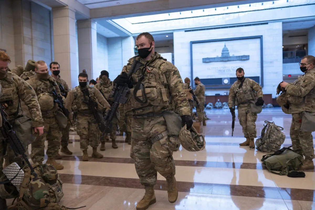 Hundreds of National Guard troops hold inside the Capitol Visitor's Center to reinforce security at the Capitol in Washington on Jan. 13, 2021. (J. Scott Applewhite/AP Photo)