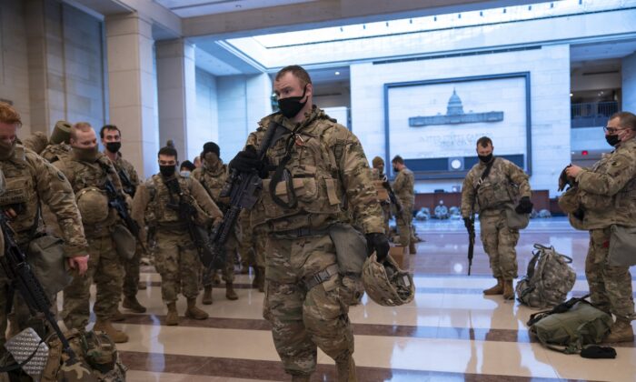 Hundreds of National Guard troops hold inside the Capitol Visitor's Center to reinforce security at the Capitol in Washington on Jan. 13, 2021. (J. Scott Applewhite/AP Photo)