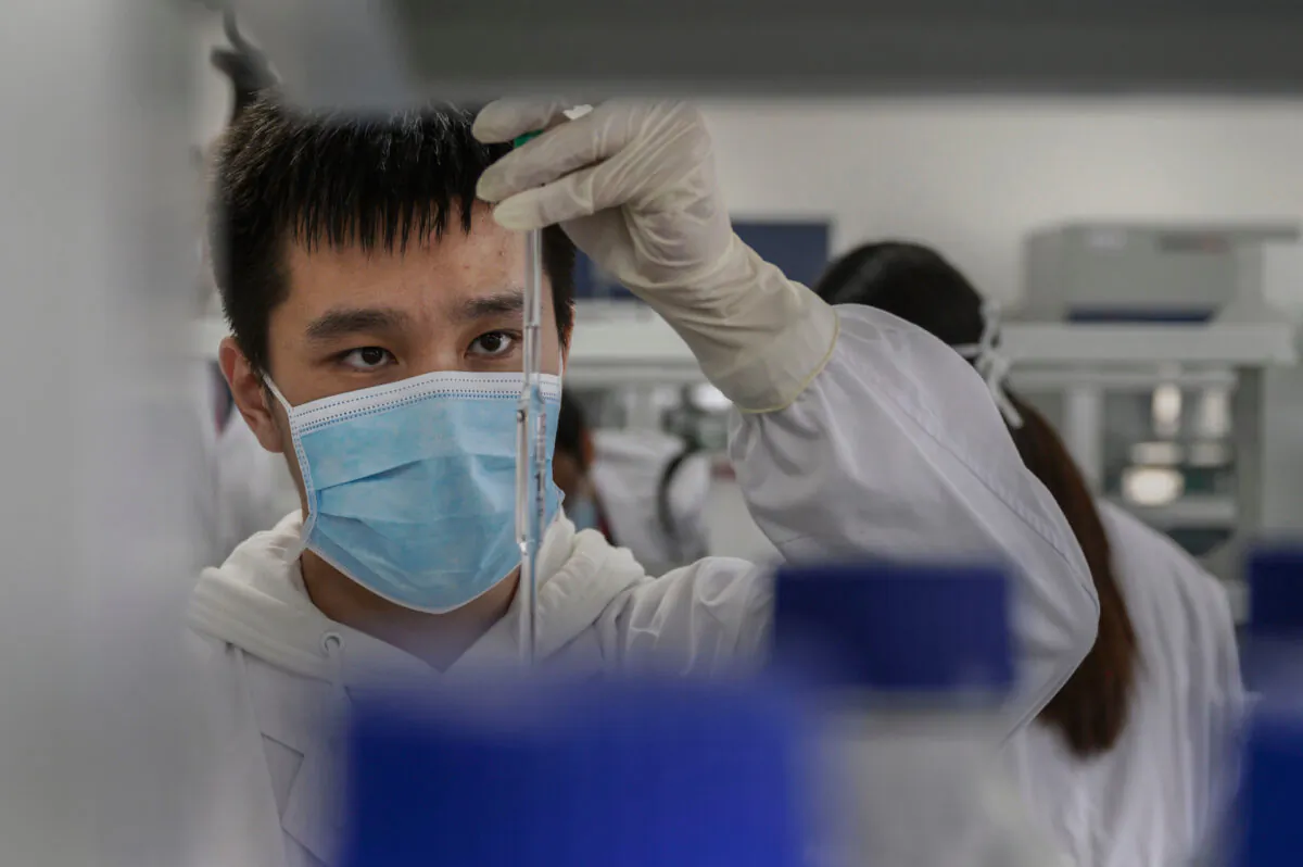 A technician works in a lab at Sinovac Biotech, where the company is producing its potential COVID-19 vaccine CoronaVac, during a media tour in Beijing on Sept. 24, 2020. (Kevin Frayer/Getty Images)