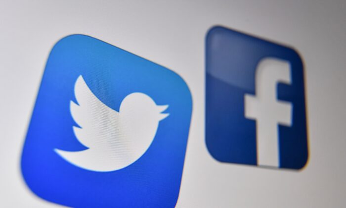 A photo shows the logo of the the American online social media and social networking service, Facebook and Twitter on a computer screen on Oct. 21, 2020. (Denis Charlet/AFP via Getty Images)