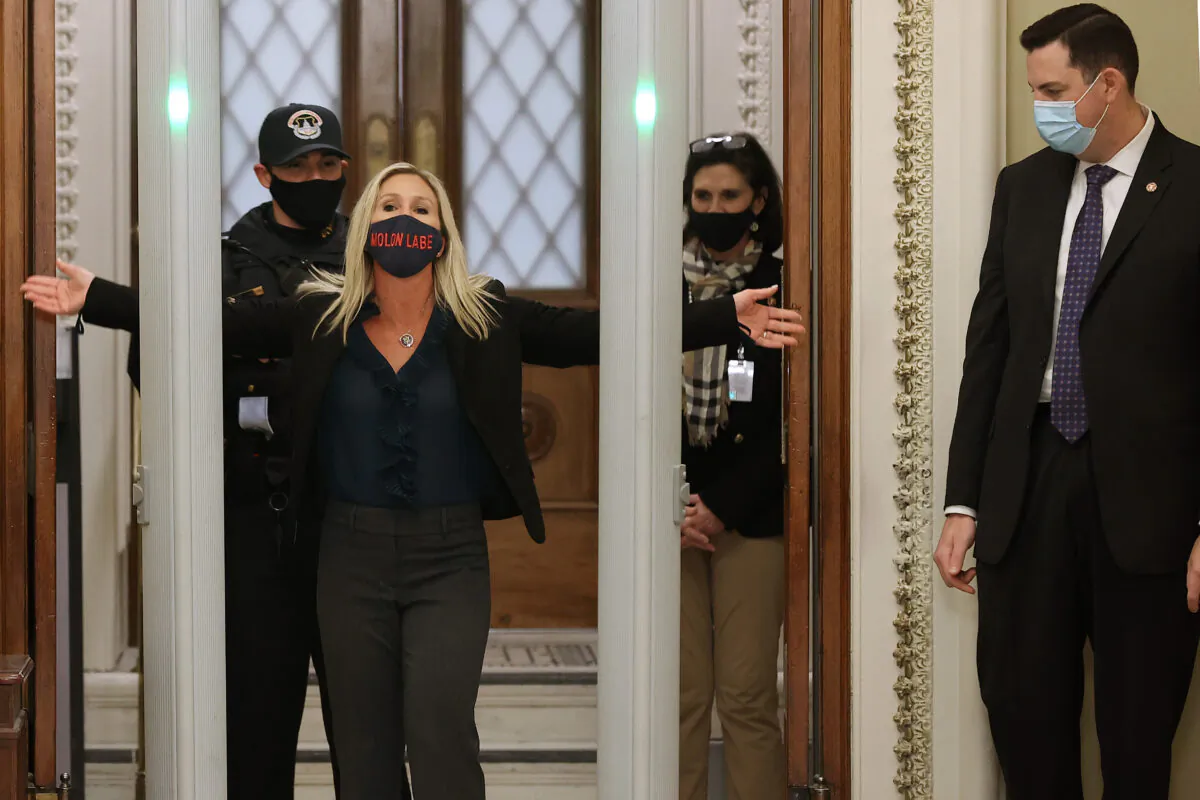 Rep. Marjorie Taylor Greene (R-Ga.) is searched by U.S. Capitol Police after setting off the metal detector outside the doors to the House of Representatives Chamber in Washington on Jan. 12, 2021. (Chip Somodevilla/Getty Images)
