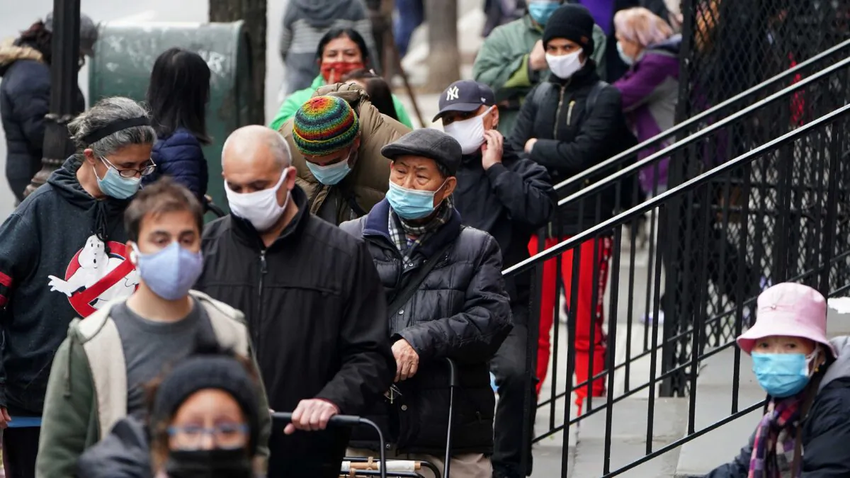 People wait in line at the St. Clements Food Pantry for food in the Manhattan borough of New York City, N.Y., on Dec. 11, 2020. (Carlo Allegri/Reuters)
