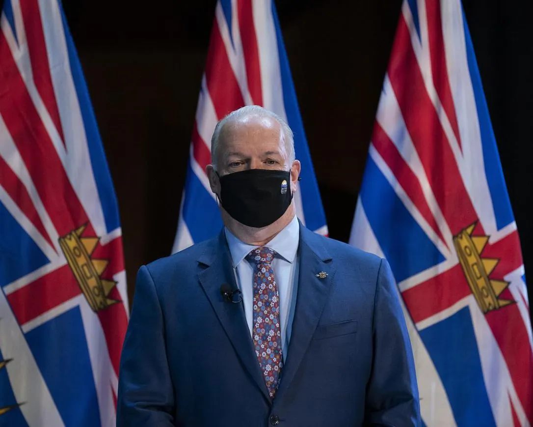 B.C. Premier John Horgan wears a protective face mask to help prevent the spread of COVID-19 prior to being sworn in by The Honourable Janet Austin, Lieutenant Governor of British Columbia during a virtual swearing in ceremony in Victoria, on November 26, 2020. (The Canadian Press/Jonathan Hayward) 