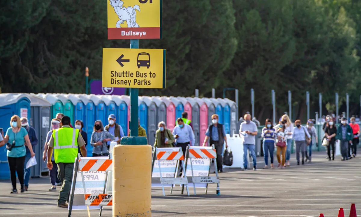 People wait in line to receive COVID-19 vaccinations at the newly opened point of distribution at Disneyland Resort in Anaheim, Calif., on Jan. 13, 2021. (John Fredricks/The Epoch Times)