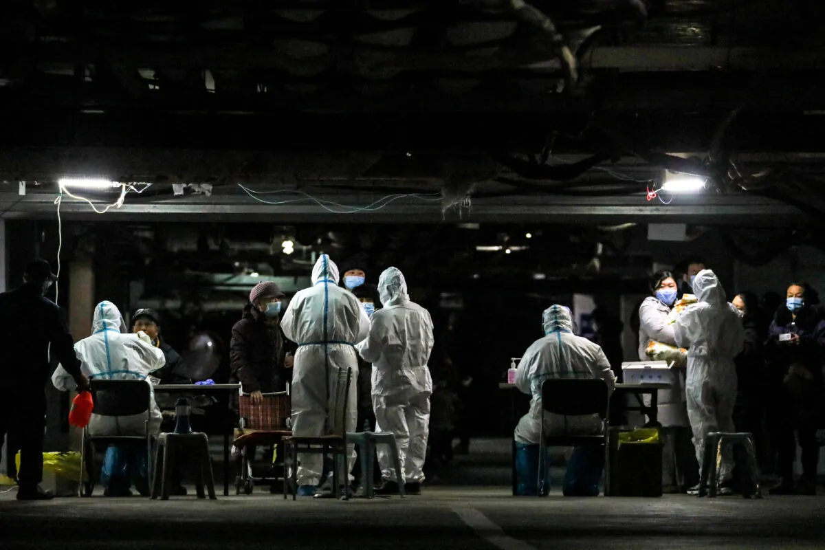 Residents undergo COVID-19 testing in the basement of a residential compound as part of a mass testing program following new cases of the virus emerging in Shijiazhuang, in northern China's Hebei Province on Jan. 12, 2021. (STR/AFP via Getty Images)
