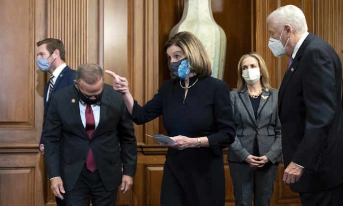 Speaker of the House Nancy Pelosi (D-Calif.) (C) arrives to sign an article of impeachment against President Donald Trump at the Capitol in Washington, D.C., on Jan. 13, 2021. (Stefani Reynolds/Getty Images)