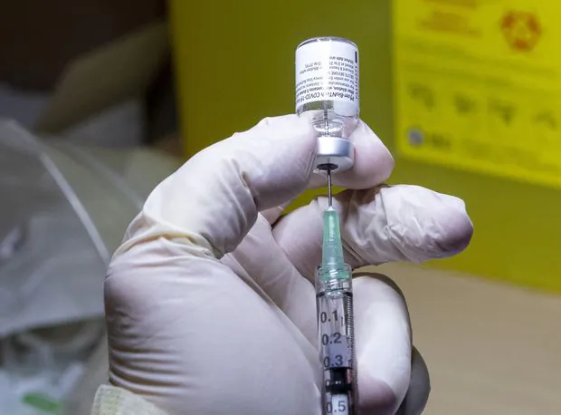 The first Pfizer-BioNTech COVID-19 vaccine dose in Canada is prepared at The Michener Institute in Toronto on Dec. 14, 2020. (The Canadian Press/Frank Gunn)