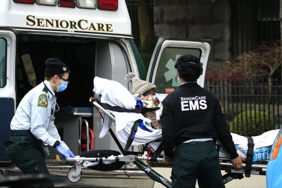File photo of emergency medical workers unloading a patient outside a nursing home in Brooklyn, N.Y., on April 18, 2020. (Justin Heiman/Getty Images)