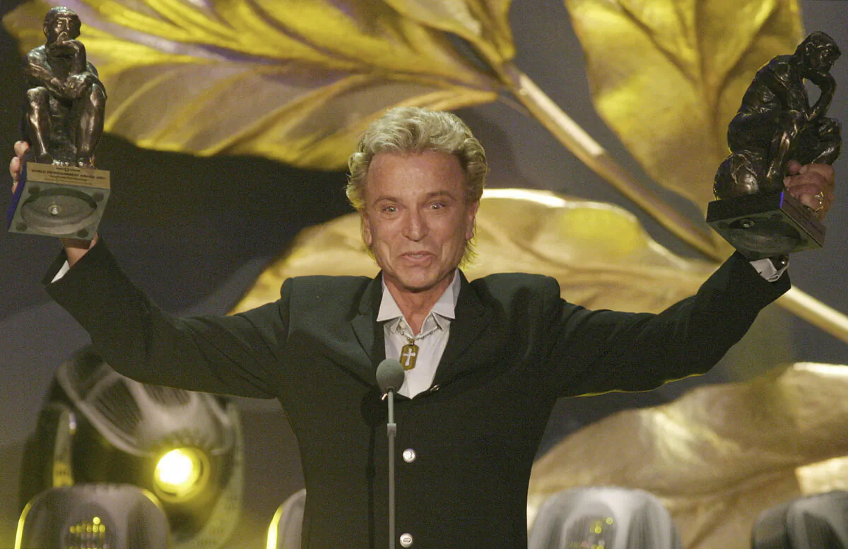 German illusionist Siegfried Fischbacher of the duo " Siegfried & Roy" holds their trophies after receiving the World Entertainment Award at the World Award 2003 ceremony in Hamburg, Germany, on Oct. 22, 2003. (Fabian Bimmer/AP Photo File)