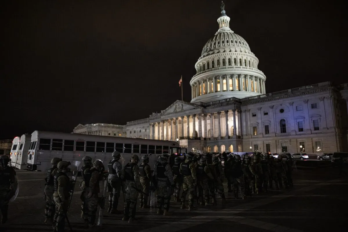 The U.S. Capitol is seen with law enforcement officers outside in Washington on Jan. 6, 2021. (Samuel Corum/Getty Images)