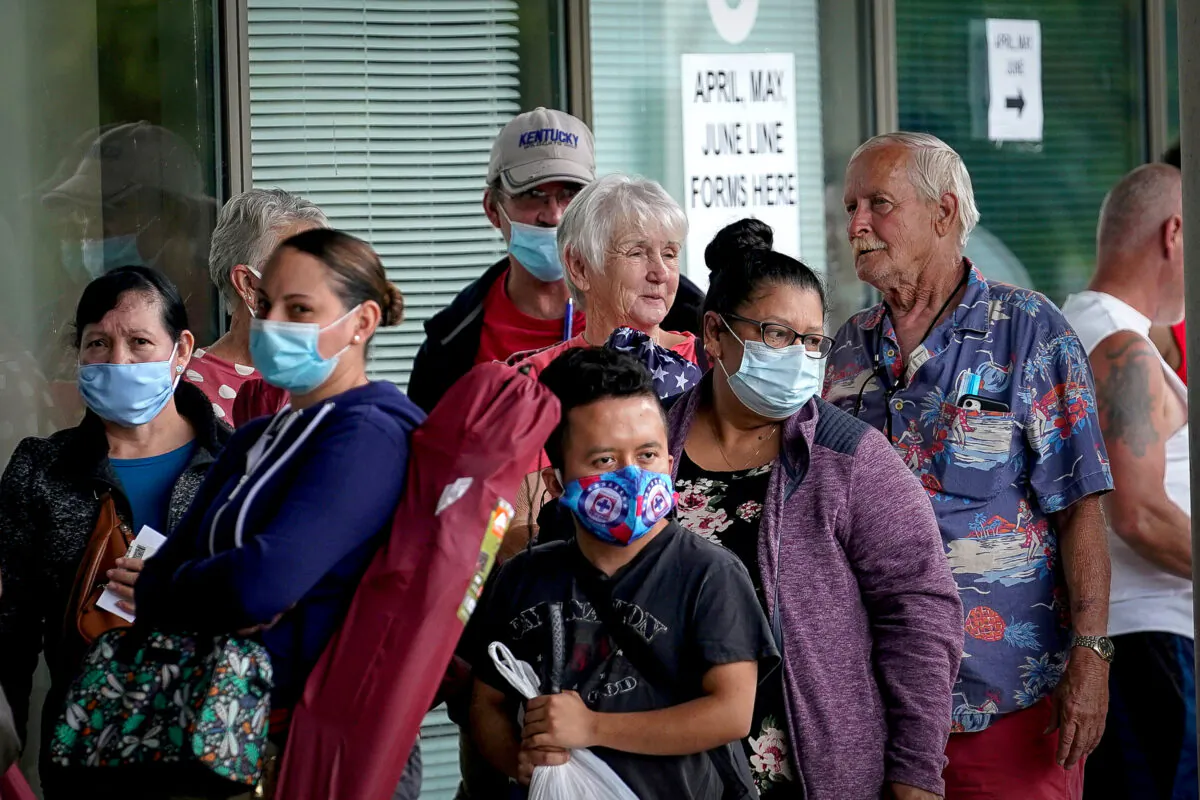 People line up outside a Kentucky Career Center hoping to find assistance with their unemployment claim in Frankfort, Ky. on June 18, 2020. (Bryan Woolston/Reuters)