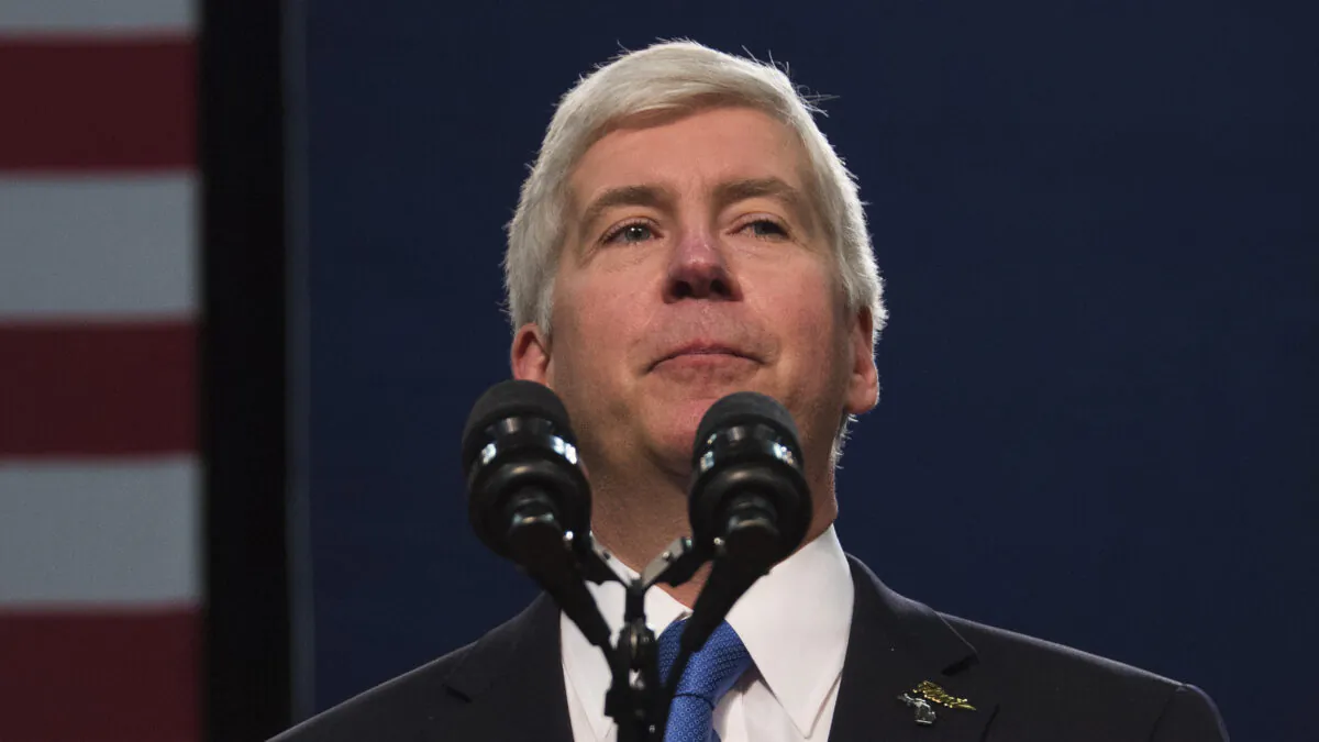 Ex-Michigan Governor Rick Snyder pauses as he is booed by the audience, as he speaks at Flint Northwestern High School in Flint, Mich., on May 4, 2016. (Jim Watson/AFP via Getty Images)