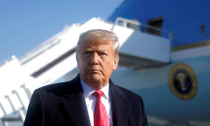 President Donald Trump looks on as he speaks to the media before boarding Air Force One to depart Washington on travel to visit the U.S.-Mexico border Wall in Texas, at Joint Base Andrews in Md., on Jan. 12, 2021. (Carlos Barria/Reuters)