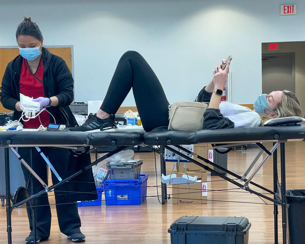 A woman gives blood during a Jan. 14 Red Cross blood drive at the Costa Mesa Senior Center. (Drew Van Voorhis/The Epoch Times)