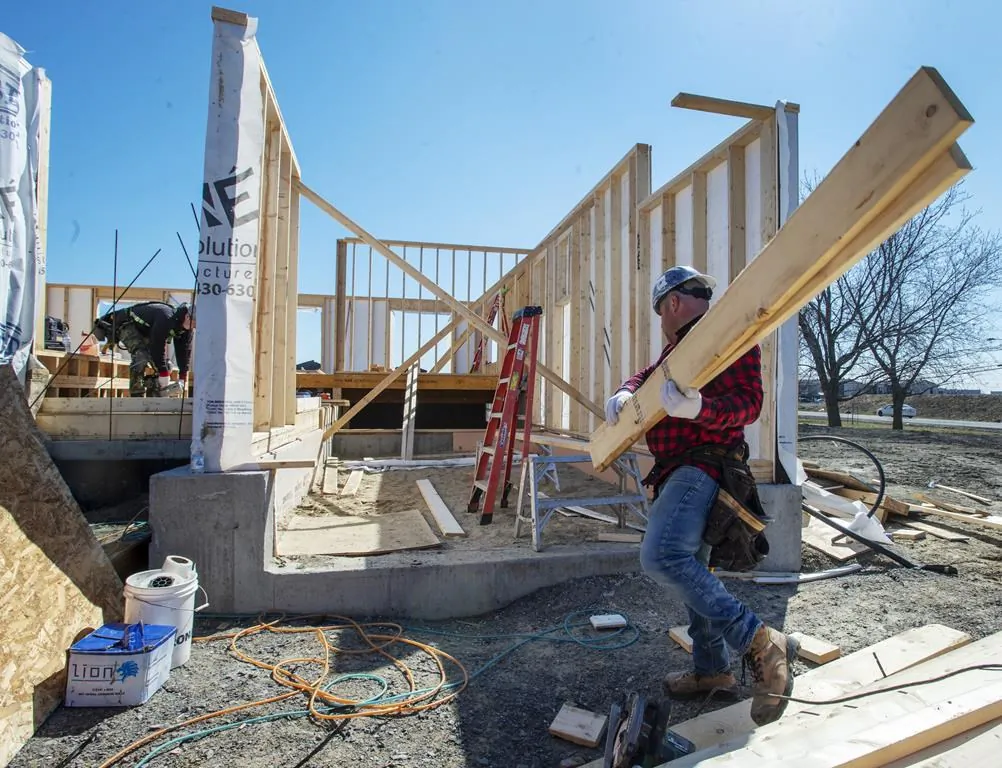 Men work on a construction site in Deux-Montagnes, Que., on April 20, 2020. (The Canadian Press/Ryan Remiorz)