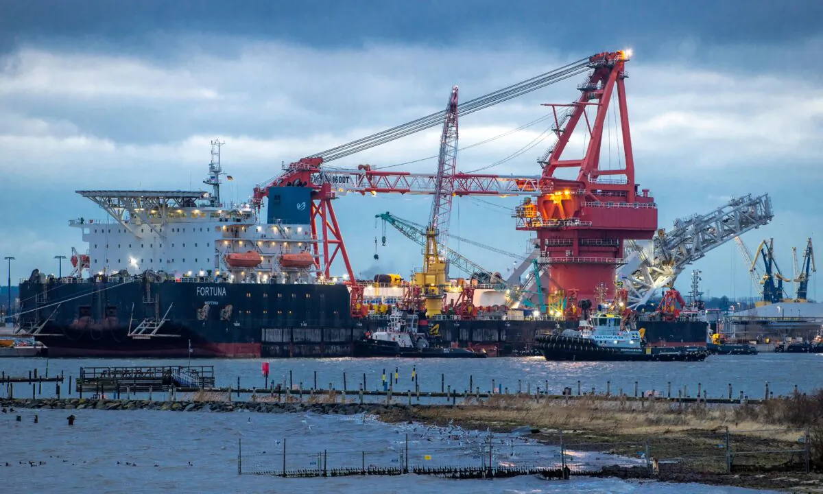 Tugboats get into position on the Russian pipe-laying vessel "Fortuna" in the port of Wismar, Germany, on Jan 14, 2021. The special vessel is being used for construction work on the German-Russian Nord Stream 2 gas pipeline in the Baltic Sea. (Jens Buettner/dpa via AP)