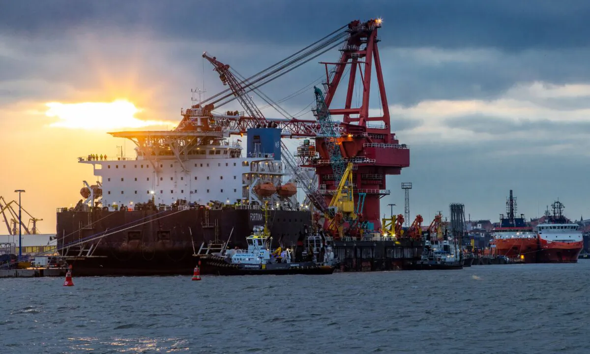 Tugboats get into position on the Russian pipe-laying vessel "Fortuna" in the port of Wismar, Germany, on Jan 14, 2021. (Jens Buettner/dpa via AP)