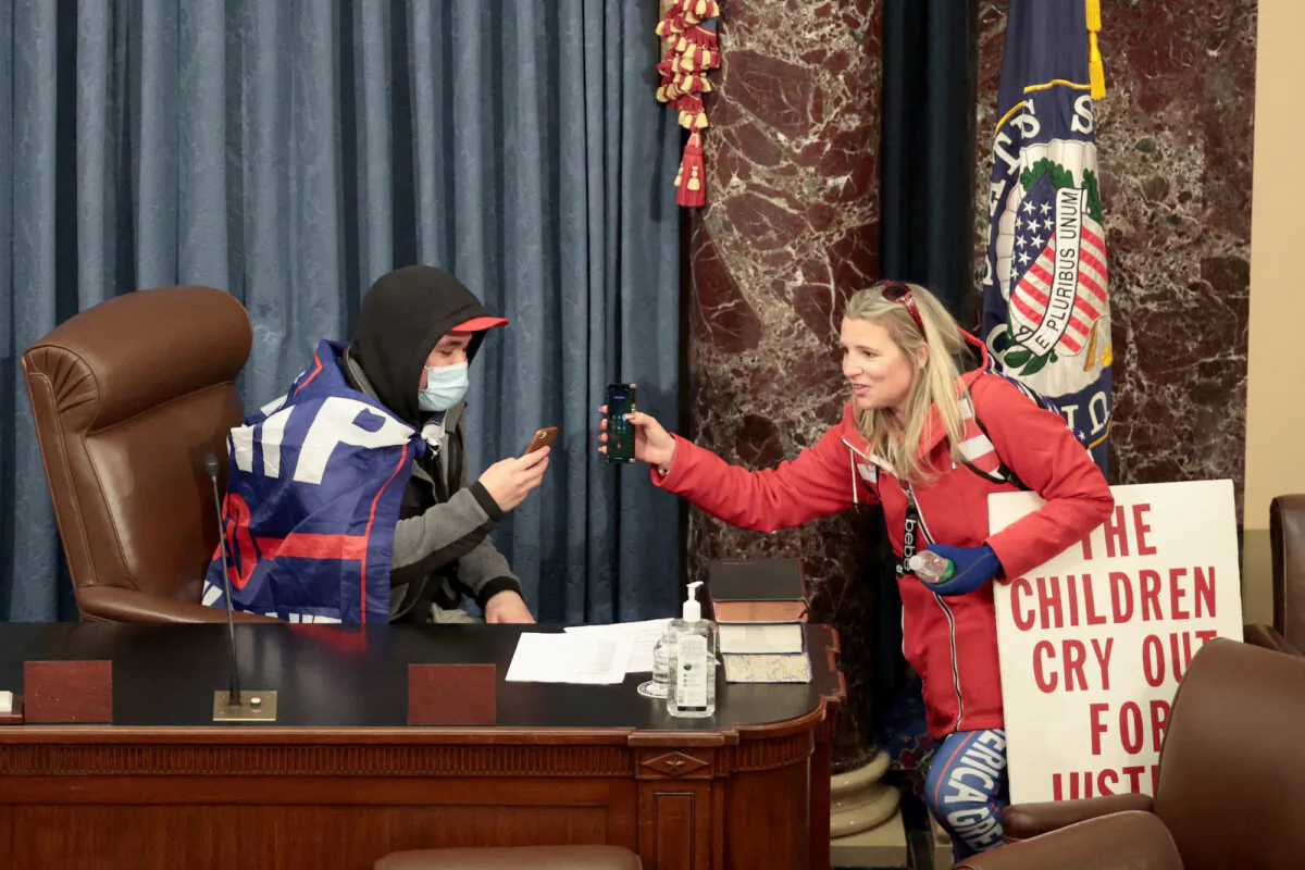 Authorities allege Christine Priola, a former therapist for the Cleveland Schools, is the woman on the right in the chambers of the Senate during an illegal breach of the U.S. Capitol on Jan. 6, 2020. (Win McNamee/Getty Images)
