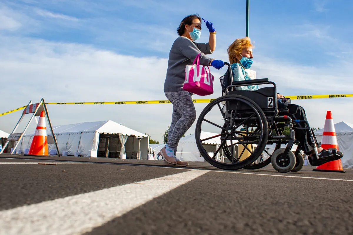 People exit after recieving a coronavirus vaccination at Disneyland theme park in Anaheim, Calif., on Jan, 13, 2021. (John Fredricks/The Epoch Times)