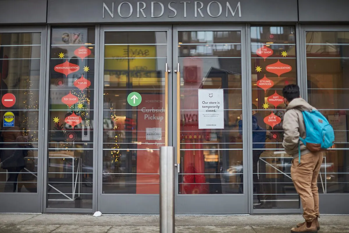 A man stands in front of the Nordstrom store, closed for in-store shopping in downtown Toronto, on Nov. 23, 2020. (Geoff Robins/AFP via Getty Images)