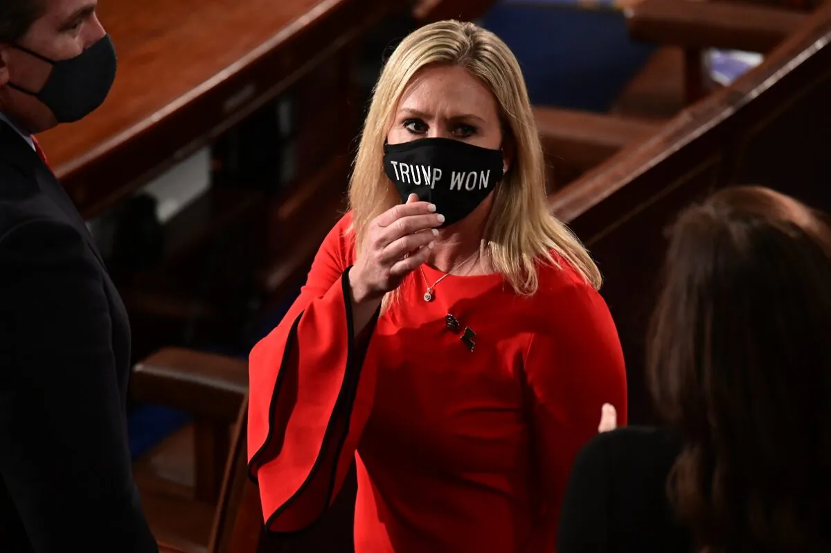 Rep. Marjorie Taylor Greene (R-Ga.) wears a "Trump Won" face mask as she arrives on the floor of the House to take the oath office on the year's opening session in Washington on Jan. 3, 2021. (Erin Scott/Pool/Getty Images)