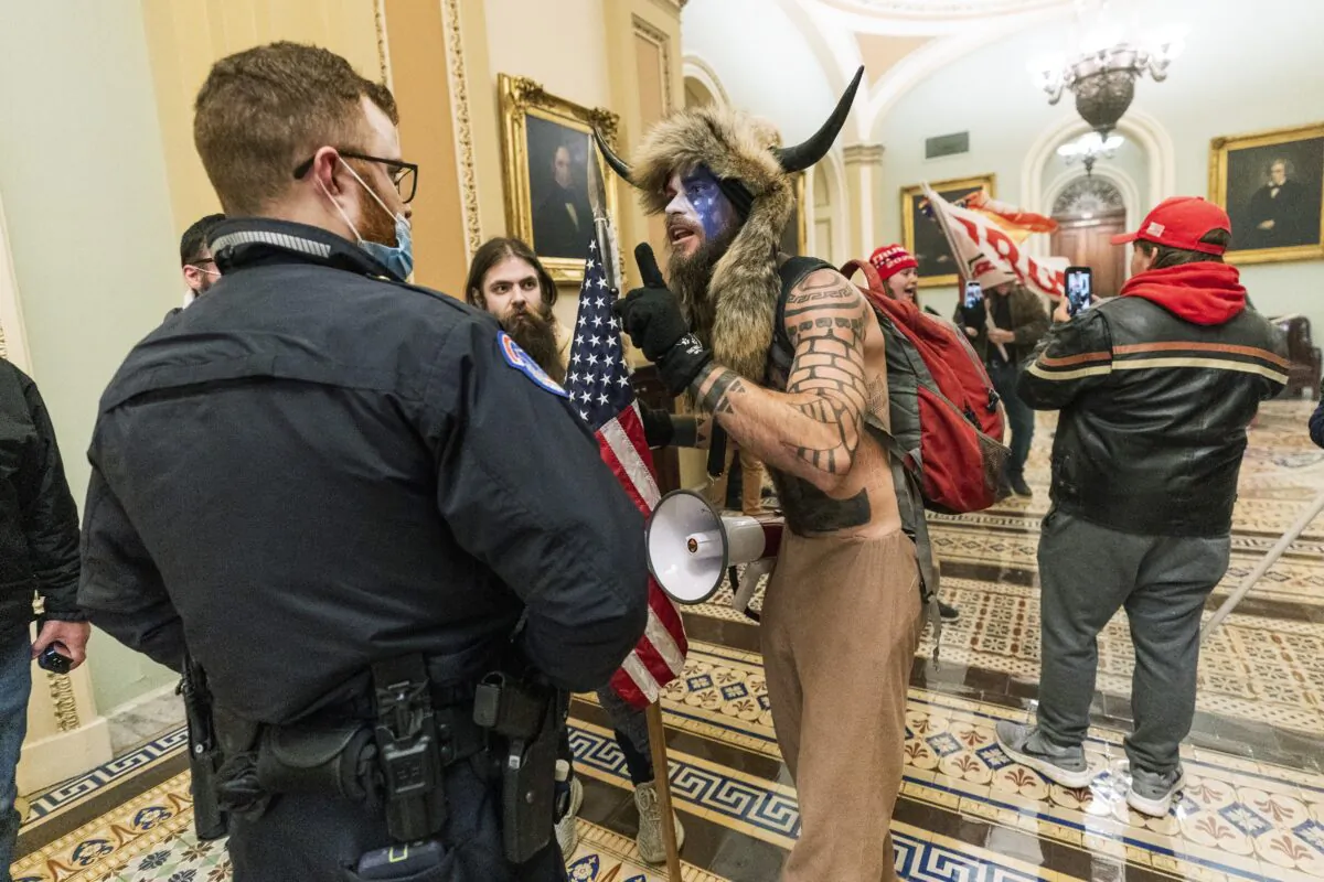 Protesters speak to U.S. Capitol Police officers outside the Senate Chamber inside the Capitol on Jan. 6, 2021. (Manuel Balce Ceneta/AP Photo)