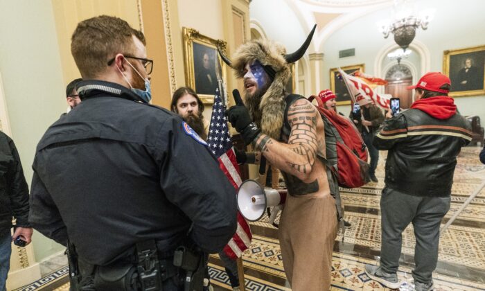 Protesters speak to U.S. Capitol Police officers outside the Senate Chamber inside the Capitol on Jan. 6, 2021. (Manuel Balce Ceneta/AP Photo)