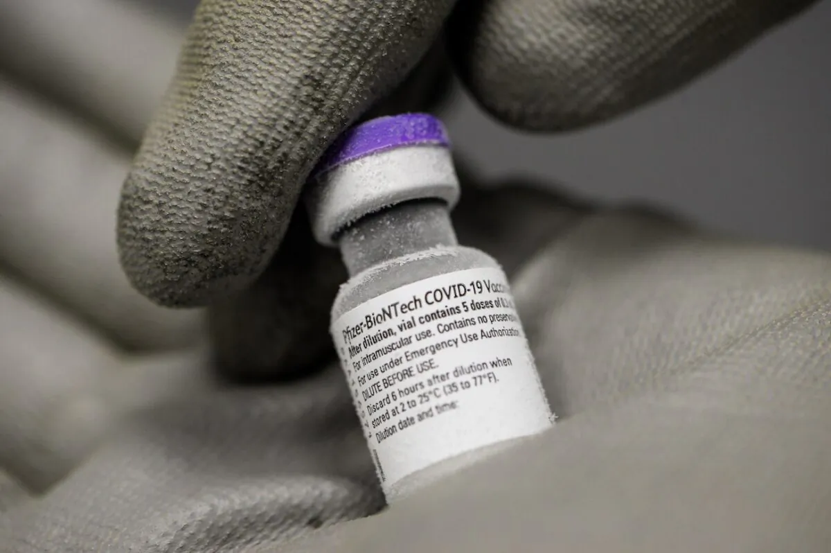 A pharmacist holding with gloved hands a vial of undiluted Pfizer-BioNTech vaccine for COVID-19 on Jan 15, 2021. (Jean-Francois Monier/AFP via Getty Images)