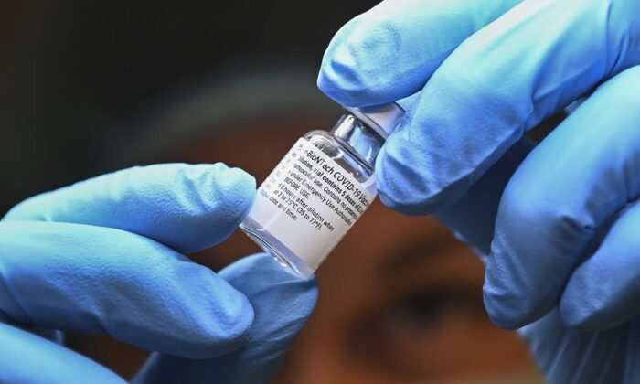 A health care worker prepares a dose of the Pfizer-BioNTech COVID-19 vaccine at a UHN COVID-19 vaccine clinic in Toronto on Jan. 7, 2021. (Nathan Denette/The Canadian Press)