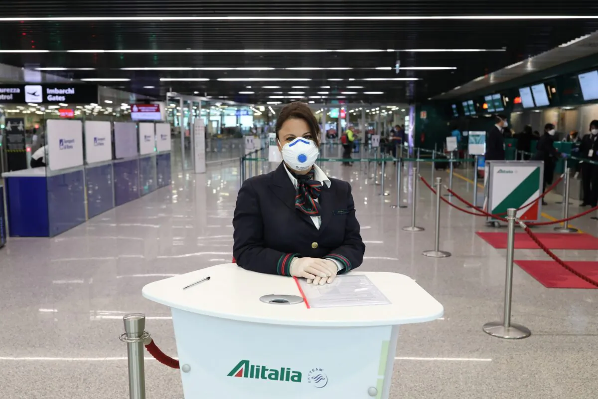 A ground assistant of the Alitalia airline company wearing a protective mask waits to assist passengers at Terminal 3 of the Leonardo Da Vinci international airport of Rome Fiumicino, in Rome, Italy, on March 17, 2020. 
(Marco Di Lauro/Getty Images)