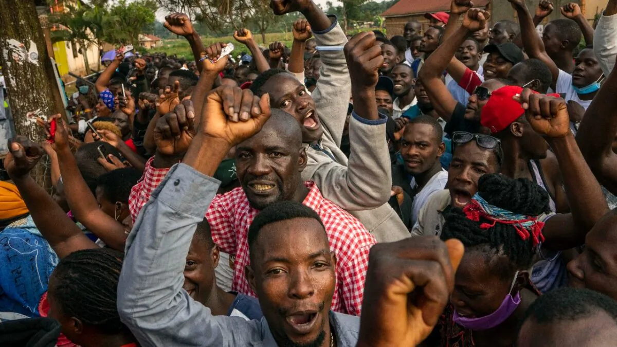 Supporters of leading opposition challenger Bobi Wine cheer as election officials count the ballots after polls closed in Kampala, Uganda, on Jan. 14, 2021. (Jerome Delay/AP)