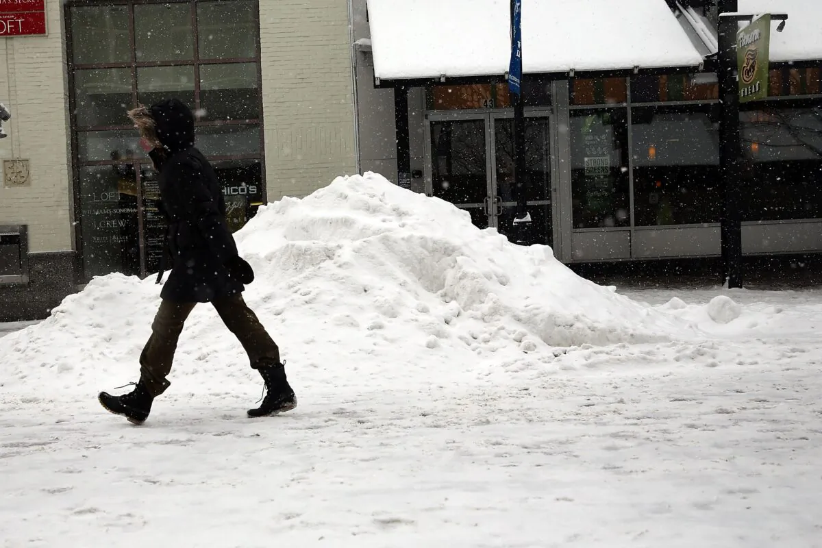 A woman walks down a street during heavy snow, in Burlington, Vt., on Feb. 5, 2014. (Spencer Platt/Getty Images)