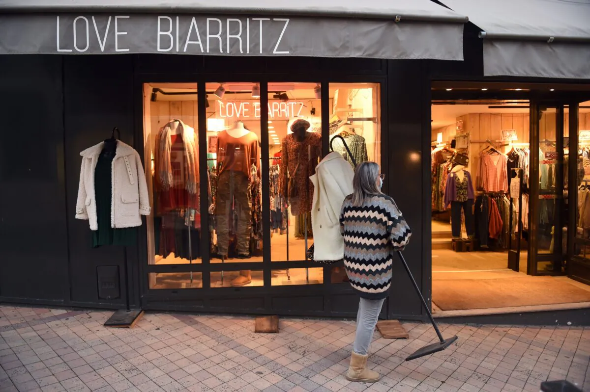 A shopkeeper closes her store, in Biarritz, southwestern France, on Jan. 16, 2021. (Gaizka Iroz/AFP via Getty Images)