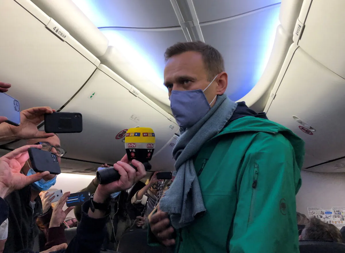 Russian opposition leader Alexei Navalny is seen on board a plane before the departure for the Russian capital Moscow at an airport in Berlin on Jan. 17, 2021. (Polina Ivanova/Reuters)