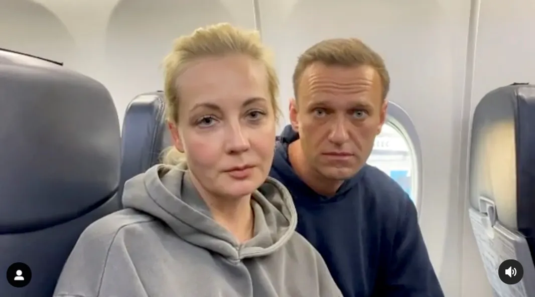 Russian opposition leader Alexei Navalny and his wife Yulia Navalnaya on board a plane before the departure for the Russian capital Moscow at an airport in Berlin, Germany, on Jan. 17, 2021. (Maria Vasilyeva/Reuters)