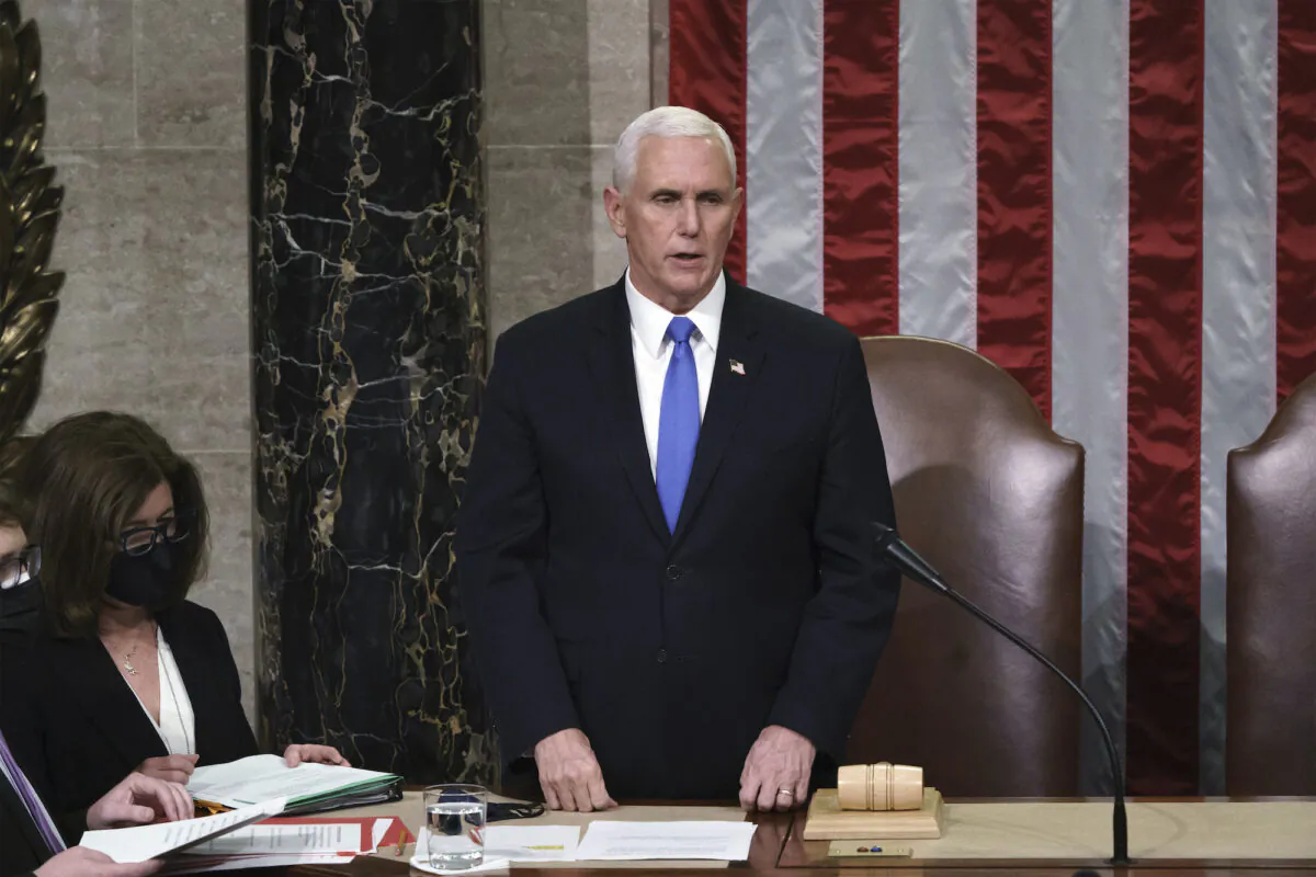 Vice President Mike Pence reads the final certification of Electoral College votes cast in November's presidential election during a joint session of Congress after working through the night, at the Capitol in Washington on Jan. 7, 2021. (J. Scott Applewhite, Pool)